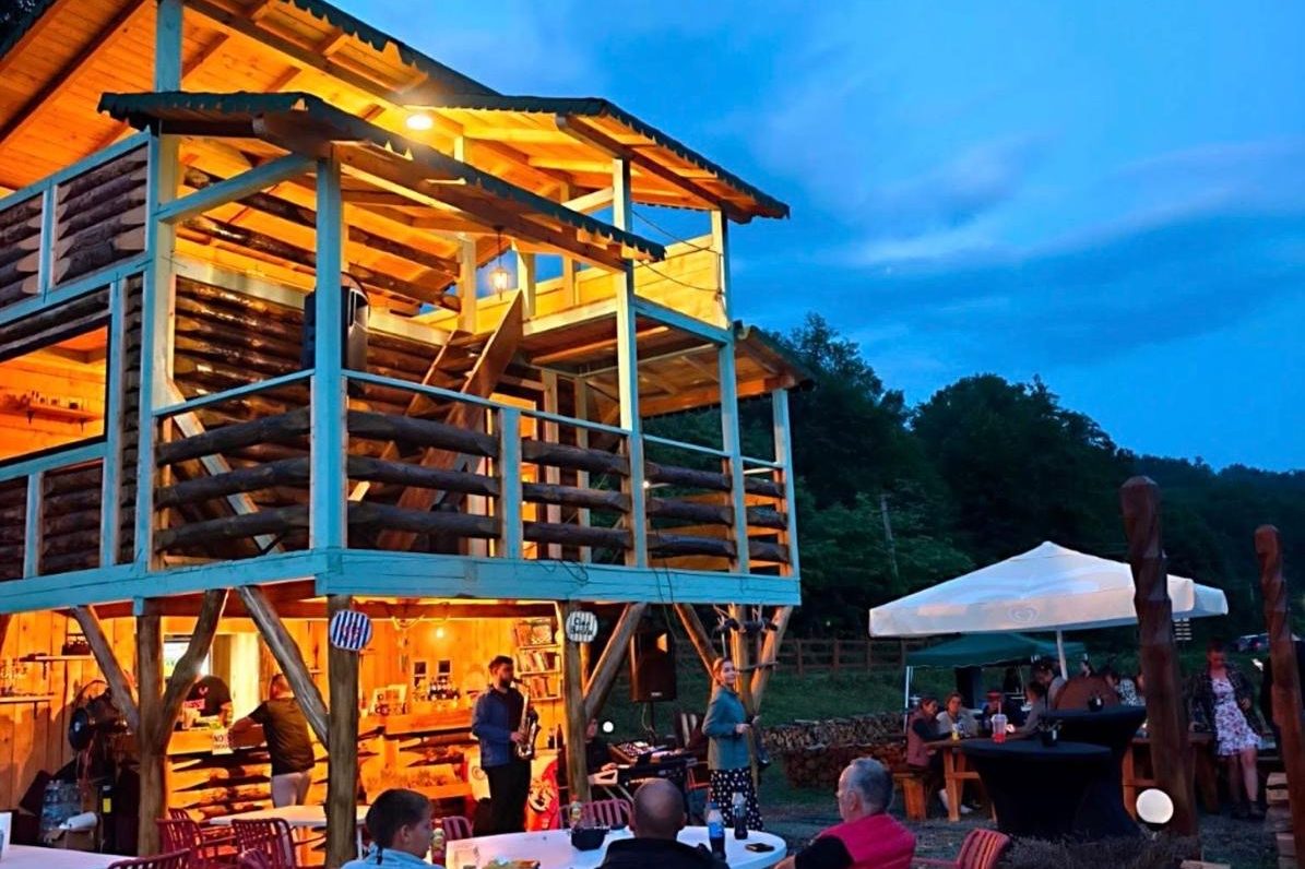 The wooden cabin at Lavandya lit up at blue hour
